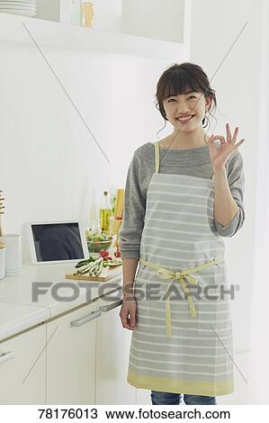 Stock Image - Japanese housewife in the kitchen. Fotosearch