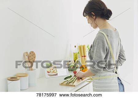 Stock Photo - Japanese housewife in the kitchen. Fotosearch