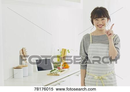 Stock Photography - Japanese housewife in the kitchen. Fotosearch