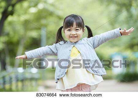 Picture - Japanese kid in a city park. Fotosearch