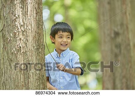 Picture - Japanese kid in a city park. Fotosearch