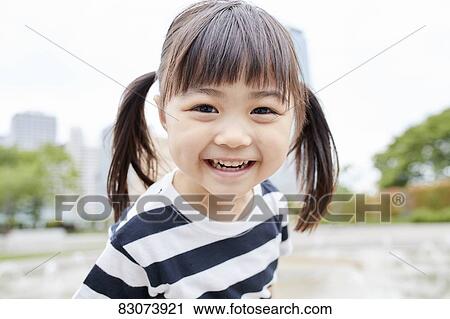 Stock Image - Japanese kid in a city park. Fotosearch