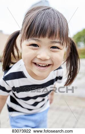 Stock Image - Japanese kid in a city park. Fotosearch