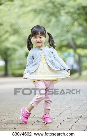 Stock Image - Japanese kid in a city park. Fotosearch