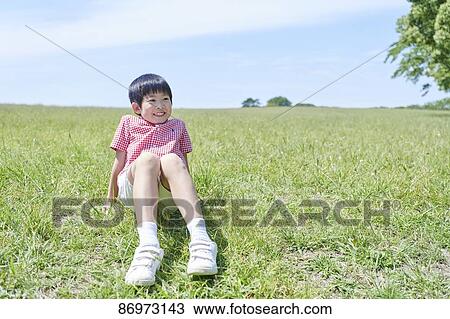 Stock Image - Japanese kid in a city park. Fotosearch