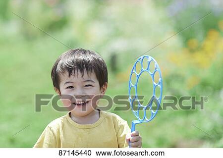 Japanese kid in a city park View Large Photo Image Stock Image - Japanese kid in a city park. Fotosearch