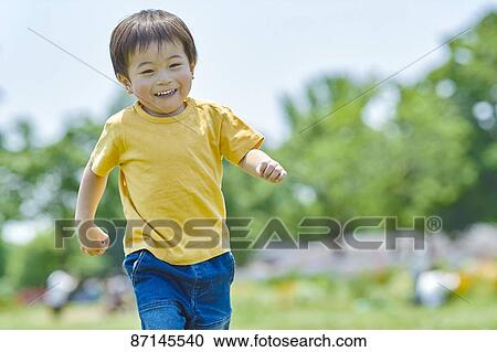 Stock Image - Japanese kid in a city park. Fotosearch