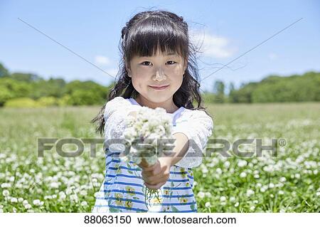 Stock Image - Japanese kid in a city park. Fotosearch