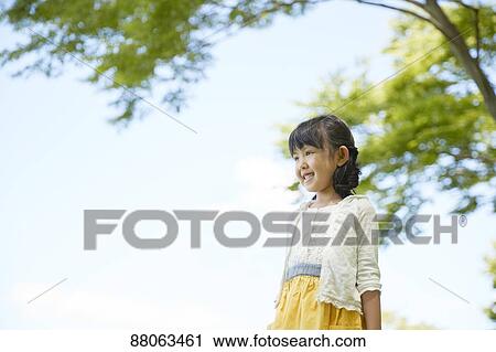 Stock Image - Japanese kid in a city park. Fotosearch