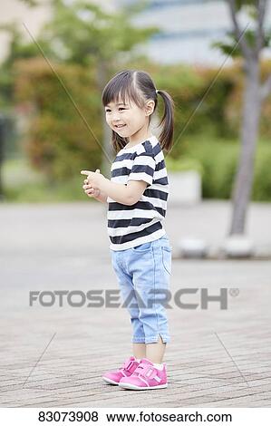 Stock Photo - Japanese kid in a city park. Fotosearch
