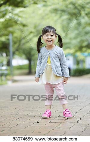 Stock Photo - Japanese kid in a city park. Fotosearch