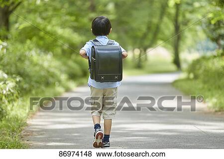 Stock Photo - Japanese kid in a city park. Fotosearch
