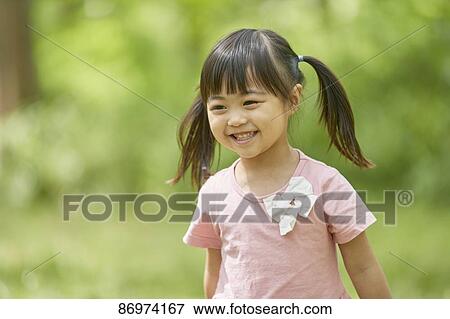 Stock Photo - Japanese kid in a city park. Fotosearch