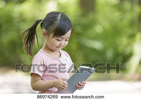 Japanese kid in a city park View Large Photo Image Stock Photo - Japanese kid in a city park. Fotosearch