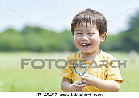 Japanese kid in a city park View Large Photo Image Stock Photo - Japanese kid in a city park. Fotosearch