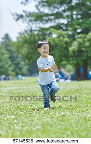 Japanese kid in a city park View Large Photo Image Stock Photograph - Japanese kid in a city park. Fotosearch