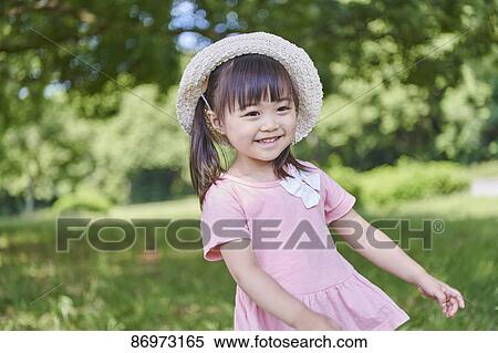 Stock Photography - Japanese kid in a city park. Fotosearch