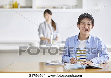 Picture - Japanese kid studying at home. Fotosearch
