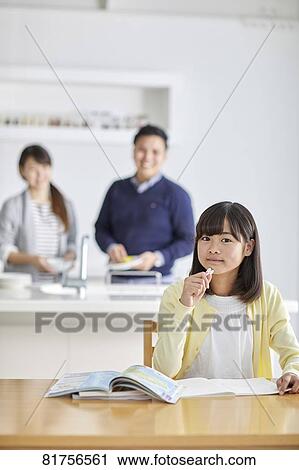 Stock Image - Japanese kid studying at home. Fotosearch