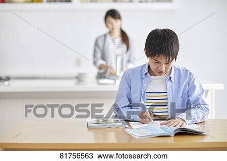 Stock Image - Japanese kid studying at home. Fotosearch