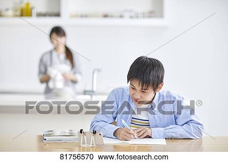 Stock Image - Japanese kid studying at home. Fotosearch