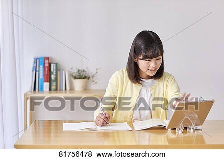 Stock Photo - Japanese kid studying at home. Fotosearch