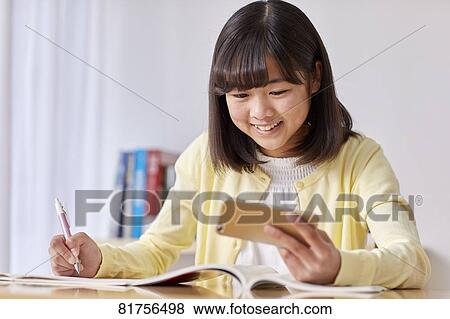 Japanese kid studying at home View Large Photo Image Stock Photo - Japanese kid studying at home. Fotosearch