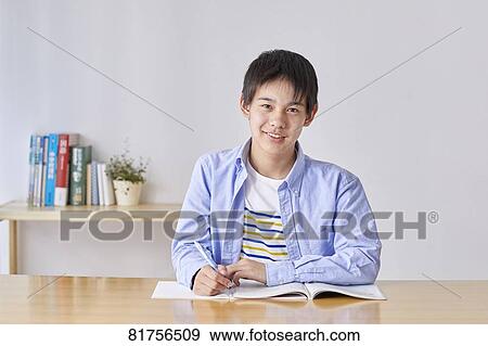 Stock Photo - Japanese kid studying at home. Fotosearch