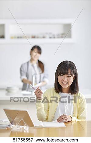 Stock Photo - Japanese kid studying at home. Fotosearch