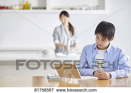 Stock Photo - Japanese kid studying at home. Fotosearch