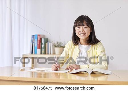 Stock Photography - Japanese kid studying at home. Fotosearch