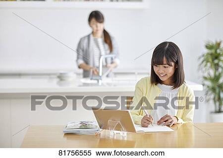 Stock Photography - Japanese kid studying at home. Fotosearch