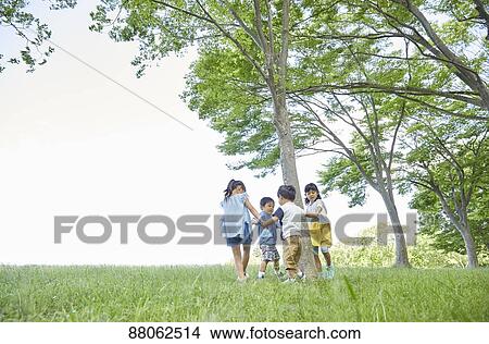 Picture - Japanese kids in a city park. Fotosearch