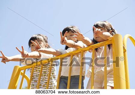 Picture - Japanese kids in a city park. Fotosearch