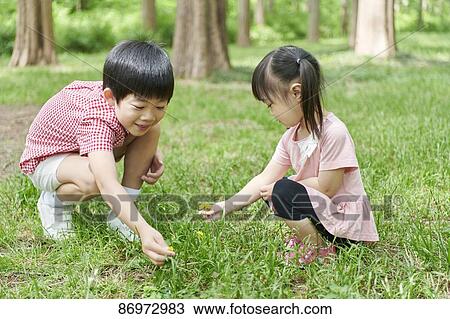 Stock Image - Japanese kids in a city park. Fotosearch