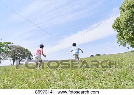Stock Image - Japanese kids in a city park. Fotosearch