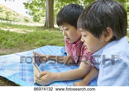Japanese kids in a city park View Large Photo Image Stock Image - Japanese kids in a city park. Fotosearch