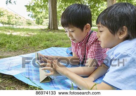 Japanese kids in a city park View Large Photo Image Stock Image - Japanese kids in a city park. Fotosearch