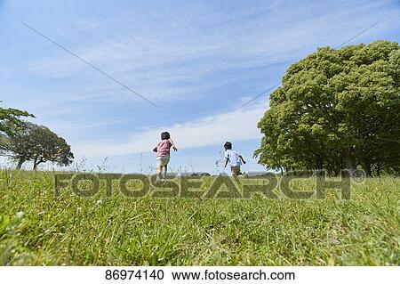 Stock Image - Japanese kids in a city park. Fotosearch