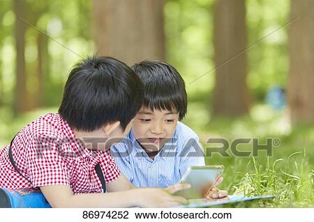 Japanese kids in a city park View Large Photo Image Stock Image - Japanese kids in a city park. Fotosearch