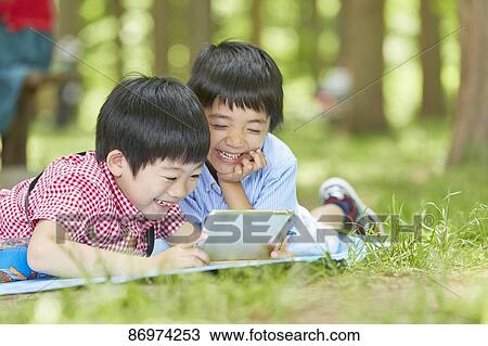 Japanese kids in a city park View Large Photo Image Stock Image - Japanese kids in a city park. Fotosearch