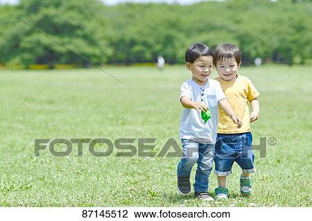 Stock Image - Japanese kids in a city park. Fotosearch