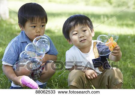 Stock Image - Japanese kids in a city park. Fotosearch