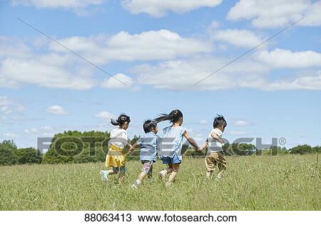 Stock Image - Japanese kids in a city park. Fotosearch