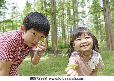 Stock Photo - Japanese kids in a city park. Fotosearch