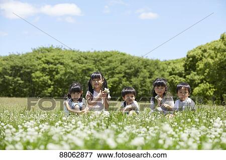 Stock Photo - Japanese kids in a city park. Fotosearch