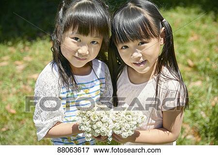 Stock Photo - Japanese kids in a city park. Fotosearch