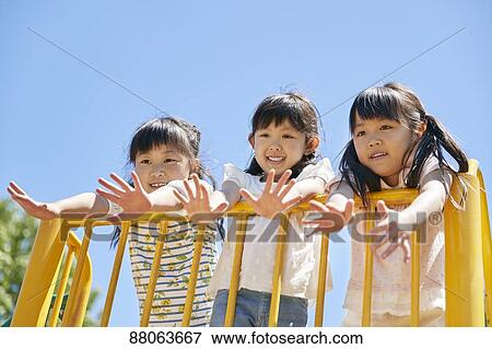 Stock Photo - Japanese kids in a city park. Fotosearch