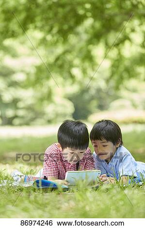 Japanese kids in a city park View Large Photo Image Stock Photograph - Japanese kids in a city park. Fotosearch