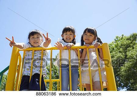 Stock Photograph - Japanese kids in a city park. Fotosearch